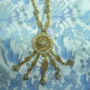 Vintage crystal long chain necklace with a playful round pendant